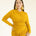 Woman wearing a yellow dress on a white background